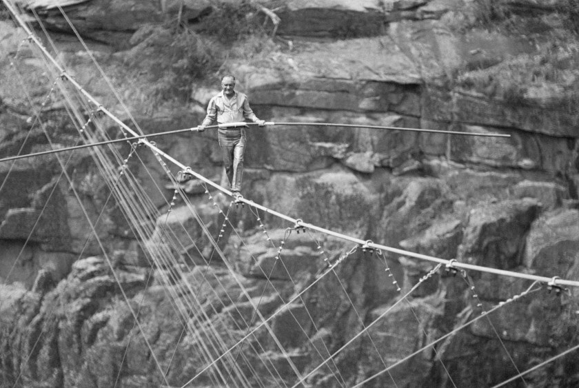 Karl Wallenda, patriarch of the Flying Wallendas tightrope troupe, walks a tightrope across the Tallulah Gorge, as an audience of 35,000 look on. (Bettmann / Contributor)