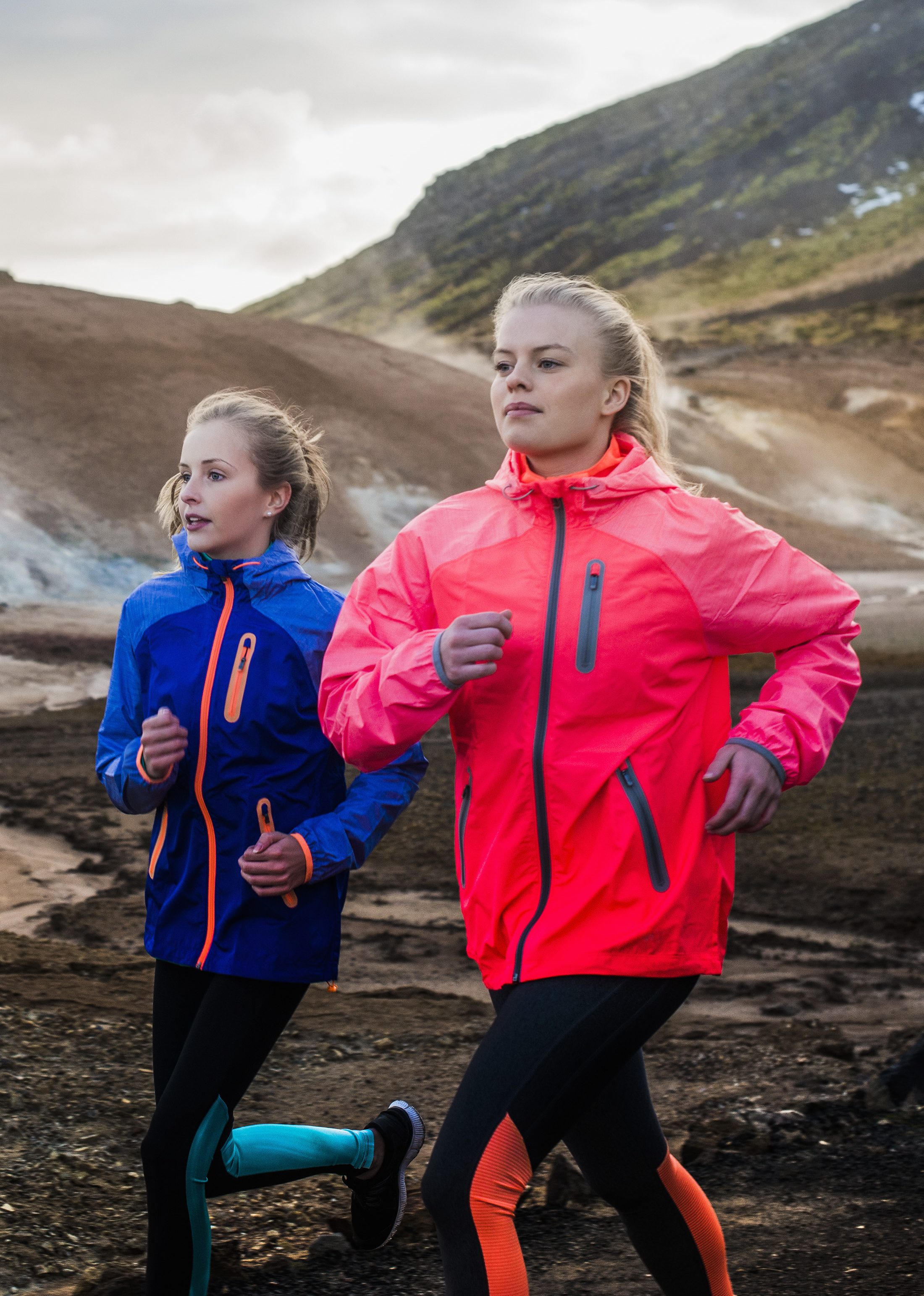 Friends running on mountain road in Iceland. (Portra Images/Getty Images)