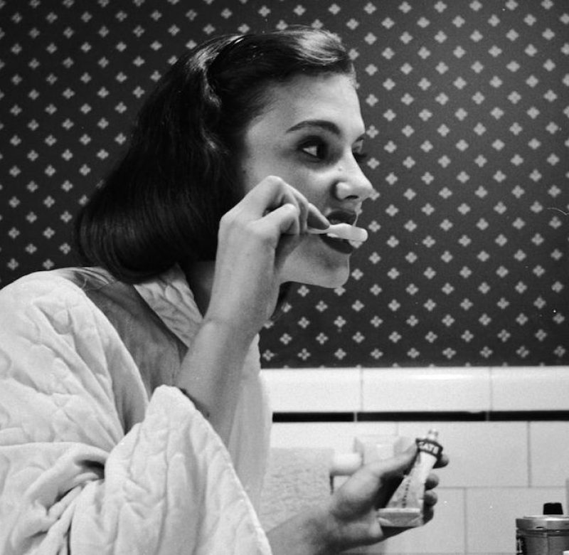 circa 1955: A young woman brushing her teeth in her bathroom. (Photo by Three Lions/Getty Images)