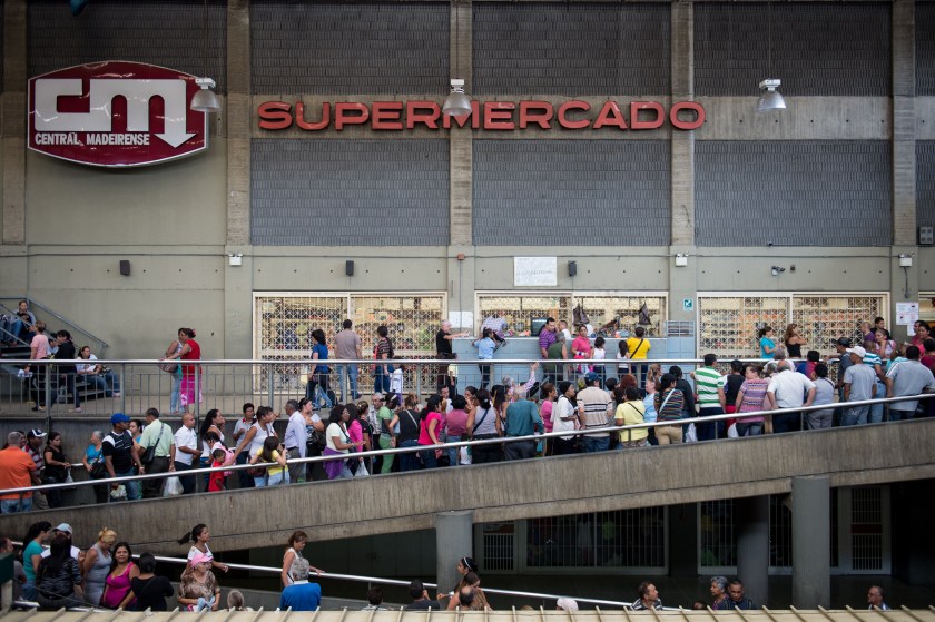 People queue up outside a supermarket in Caracas on January 13, 2015. (Federico Parra/AFP/Getty Images)