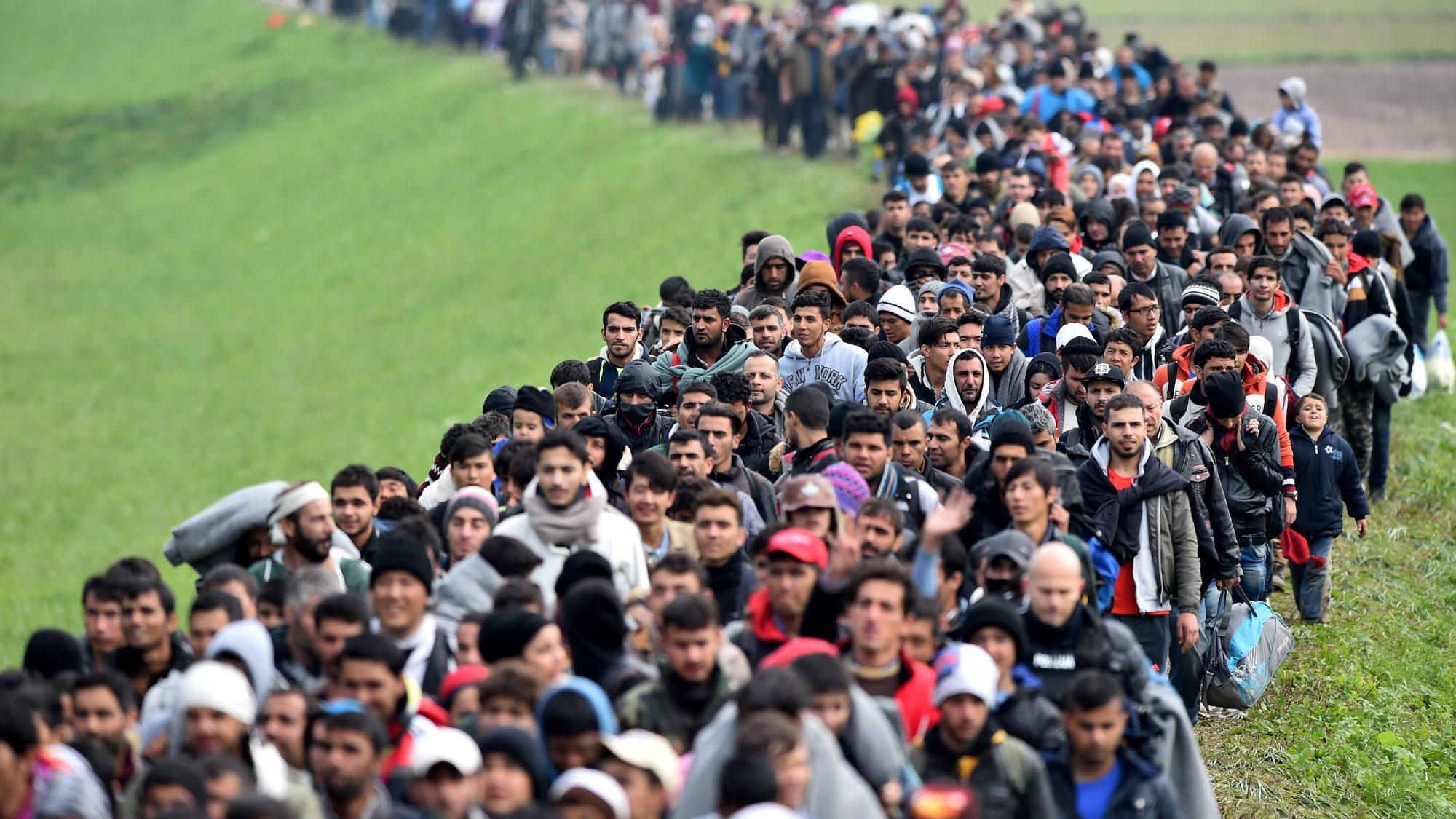 Migrants are escorted through fields by police as they are walked from the village of Rigonce to Brezice refugee camp on October 23, 2015 in Rigonce,, Slovenia. Thousands of migrants marched across the border between Croatia into Slovenia as authorities intensify their efforts to attempt to cope with Europe's largest migration of people since World War II.  (Jeff J Mitchell/Getty Images)