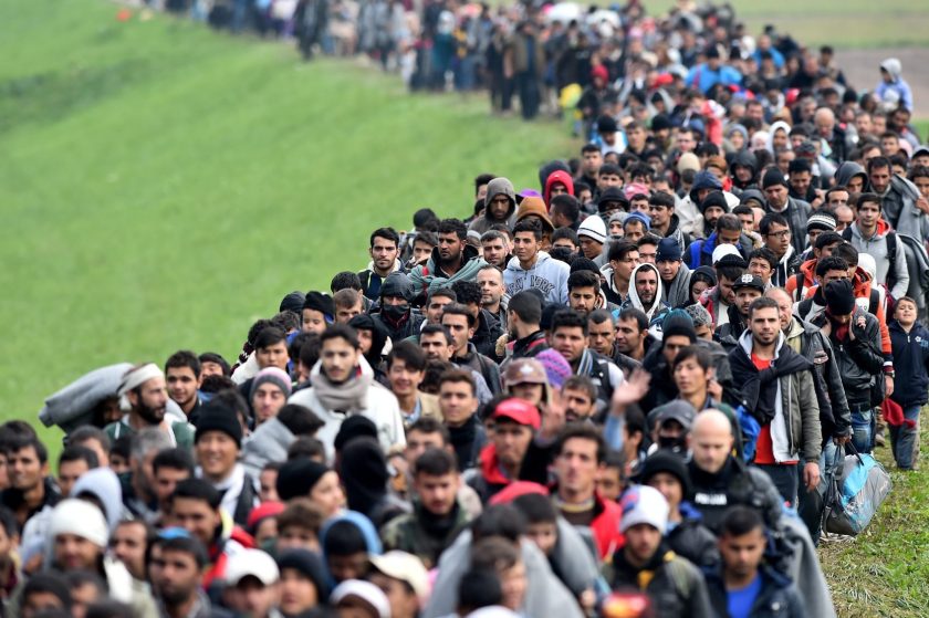 Migrants are escorted through fields by police as they are walked from the village of Rigonce to Brezice refugee camp on October 23, 2015 in Rigonce,, Slovenia. Thousands of migrants marched across the border between Croatia into Slovenia as authorities intensify their efforts to attempt to cope with Europe's largest migration of people since World War II. (Jeff J Mitchell/Getty Images)
