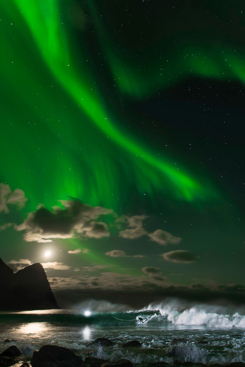 Surfer Surfing Under the Northern Lights