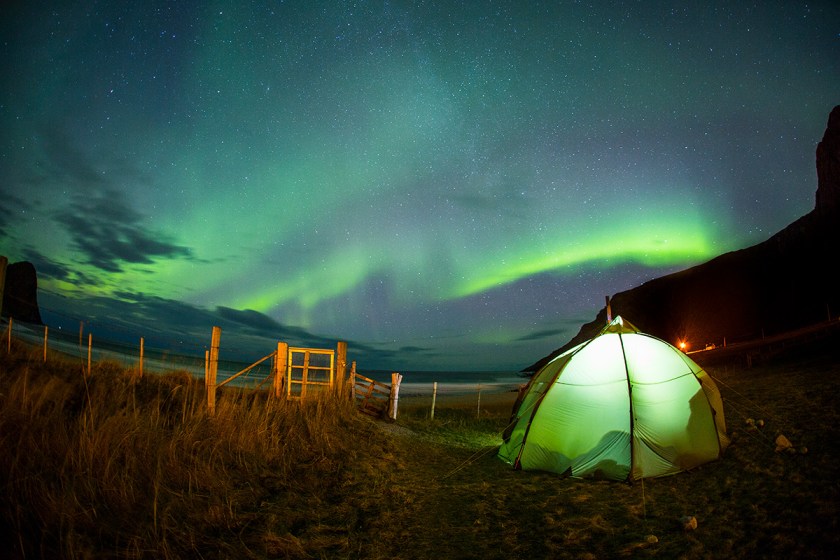 Surfer Surfing Under the Northern Lights