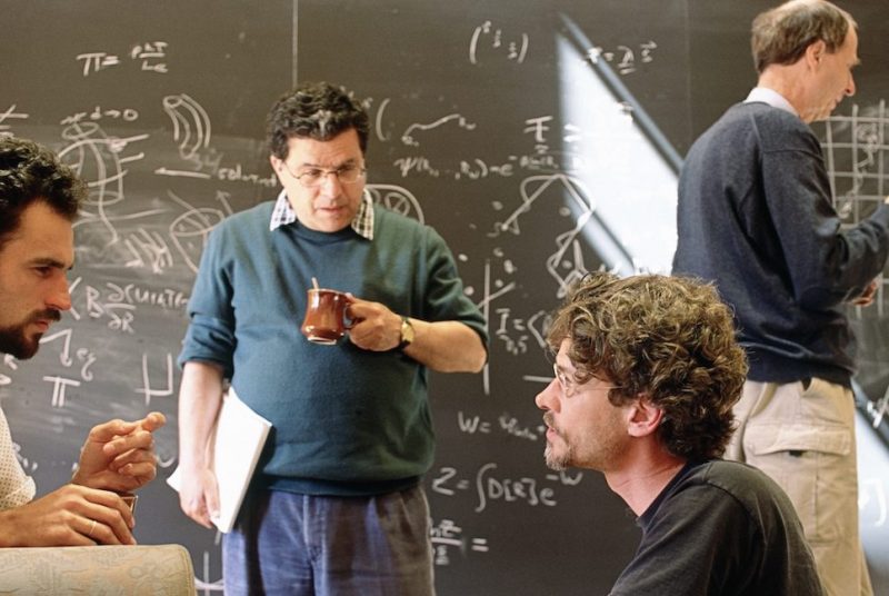 Physicists discuss their work during a coffee break