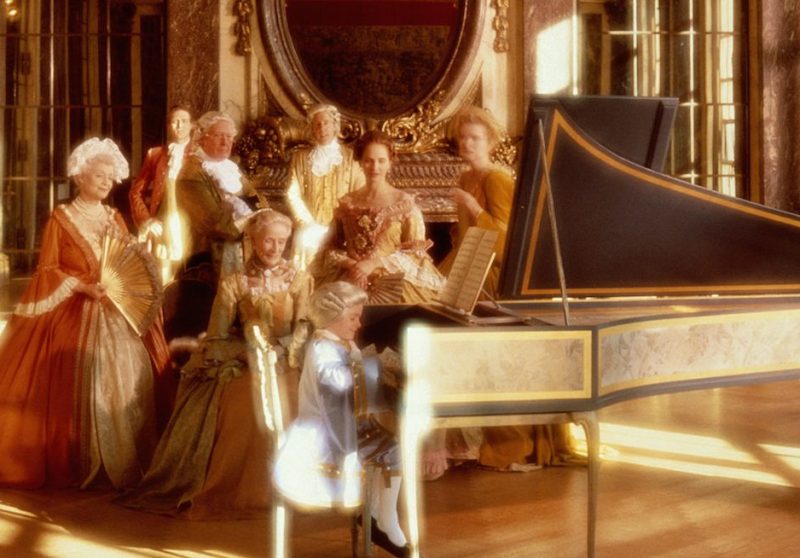 AMADEUS AT PIANO WITH ADMIRING ADULTS