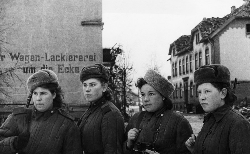 A group of young women, Soviet snipers who have 2,000 German kills between them, inspecting a small town in East Prussia after it was taken by the Soviet Army, in February of 1945. (Sovfoto/UIG via Getty Images)