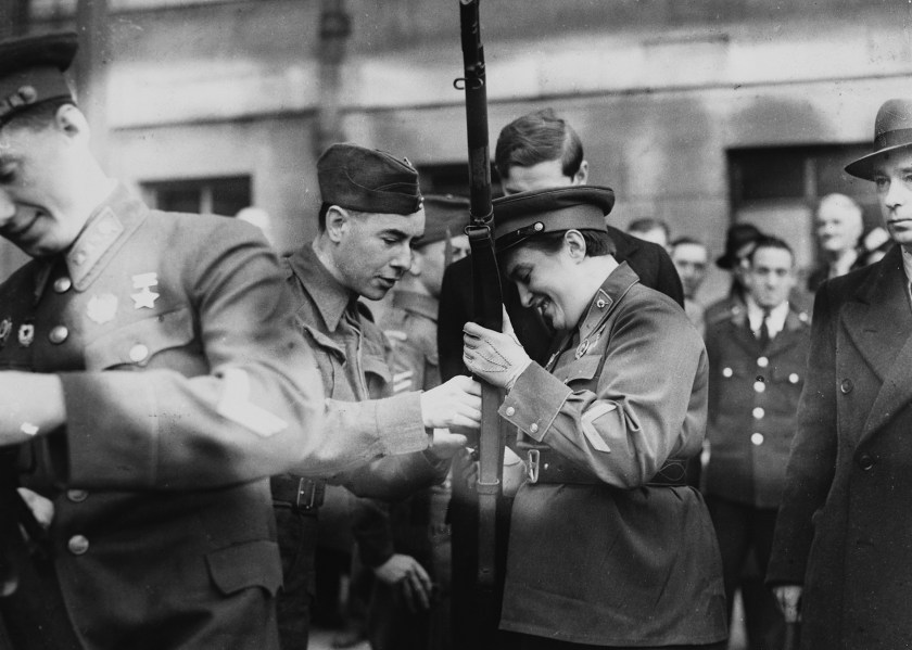Sniper Lyudmilla Pavlichenko, a Soviet lieutenant, examines the rifle of a member of the Home Guards while on a trip to London with other young Soviets. She serves as a sniper in the Soviet army and has shot 309 Germans. (Hulton-Deutsch Collection/Corbis via Getty Images)