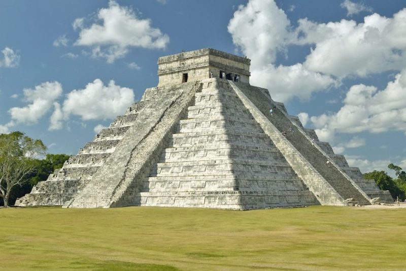 White puffy clouds over the Mayan Pyramid of Kukulkan (also known as El Castillo) and ruins at Chichen Itza, Yucatan Peninsula, Mexico