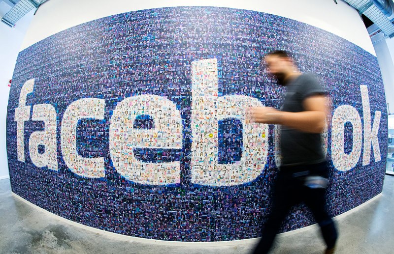 This picture taken with a fisheye lens shows a man walks past a big logo created from pictures of Facebook users worldwide in the company's Data Center, its first outside the US on November 7, 2013 in Lulea, in Swedish Lapland. The company began construction on the facility in October 2011 and went live on June 12, 2013 and are 100% run on hydro power. (Jonathan Nackstrand/AFP/Getty Images)
