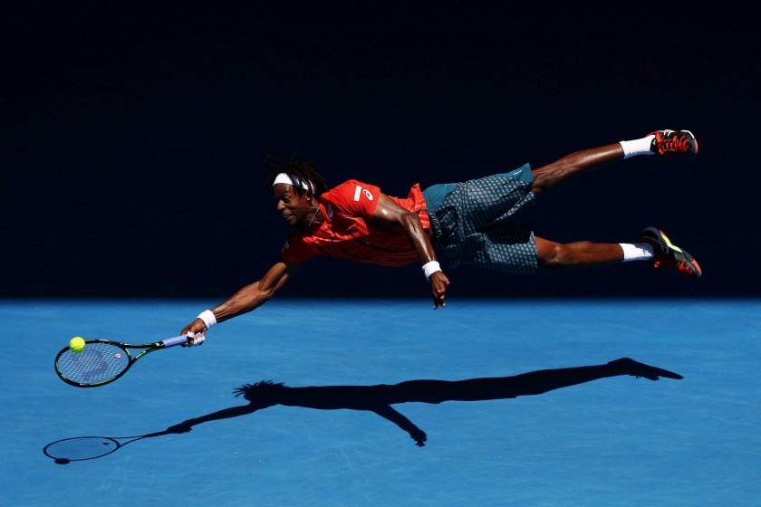 Sports - Second Prize, Singles: Gaël Monfils of France dives for a forehand in his fourth round match against Andrey Kuznetsov of Russia, during the 2016 Australian Open at Melbourne Park, Australia, on 25 January 2016. The Australian Open holds the record for the highest attendance at a Grand Slam event. (Cameron Spencer/Getty Images)