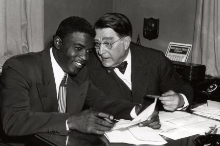 BROOKLYN - 1949.  Jackie Robinson, left, and Branch Rickey share a joke during a contract signing session in the front offices of the Brooklyn Dodgers at Ebbets Field in Brooklyn in 1949.   (Photo by Mark Rucker/Transcendental Graphics, Getty Images)