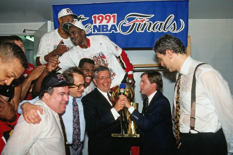 INGLEWOOD, CA - JUNE 12: Phil Jackson of the Chicago Bulls is presented the Finals trophy from NBA Commissioner David Stern after winning Game Five of the 1991 NBA Finals on June 12, 1991 at the Great Western Forum in Inglewood, California. The Chicago Bulls defeated the Los Angeles Lakers 4-1 to win the NBA Championship. NOTE TO USER: User expressly acknowledges and agrees that, by downloading and or using this photograph, User is consenting to the terms and conditions of the Getty Images License Agreement. Mandatory Copyright Notice: Copyright 1991 NBAE (Photo by Andrew D. Bernstein/NBAE via Getty Images)