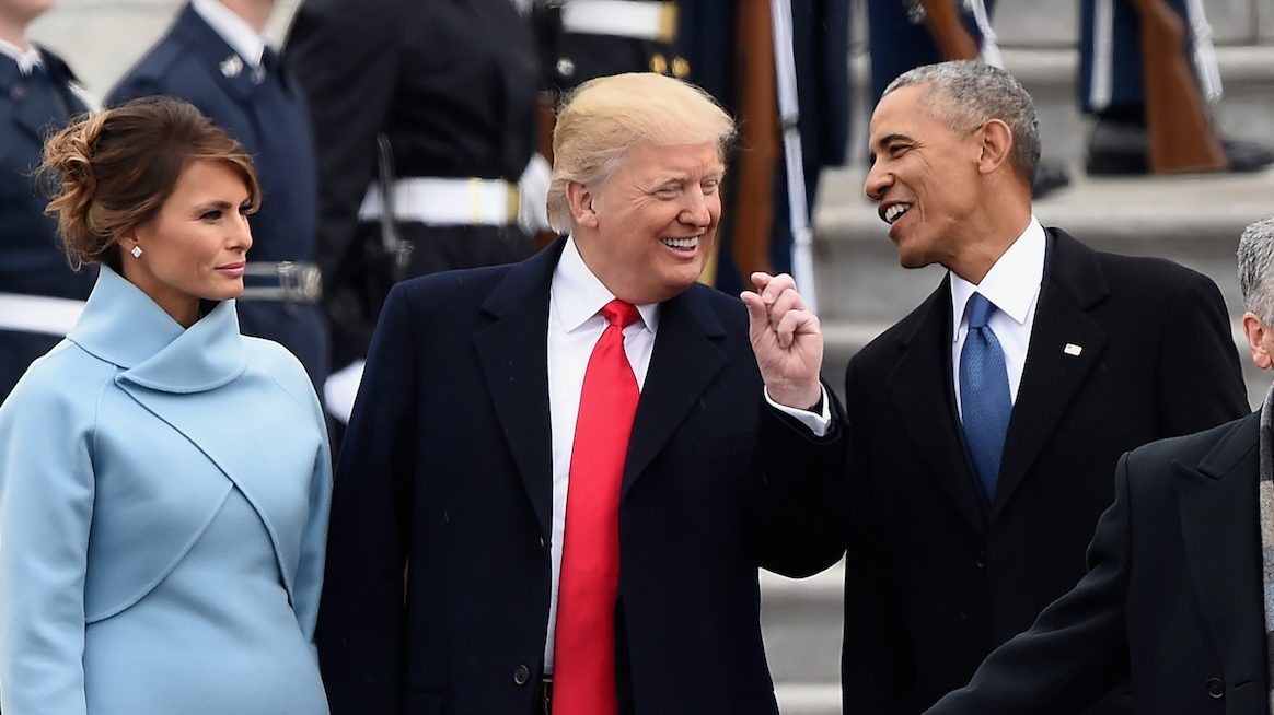 US First Lady Melania Trump looks on as US President Donald Trump and former President Barack Obama talk on the East front steps of the US Capitol after inauguration ceremonies on January 20, 2017 in Washington, DC.  / AFP / Robyn BECK        (Photo credit should read ROBYN BECK/AFP/Getty Images)