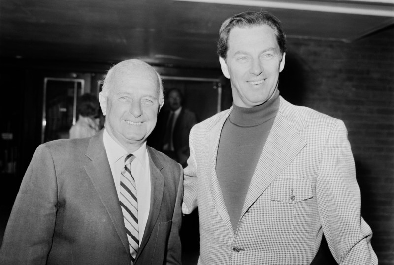 Norwegian-American businessman Kjell Qvale (1919 - 2013, right), a majority shareholder in Jensen Motors, is met at London Airport by English car designer and rally driver Donald Healey (1898 - 1988), 21st February 1971 (George Stroud/Daily Express/Getty Images)