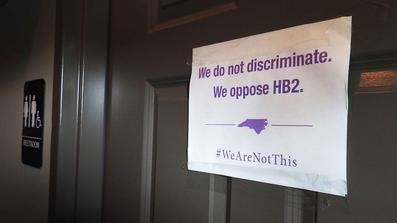A unisex sign and the 'We Are Not This' slogan are outside a bathroom at Bull McCabes Irish Pub on May 10, 2016 in Durham, North Carolina. (Sara D. Davis/Stringer/Getty)