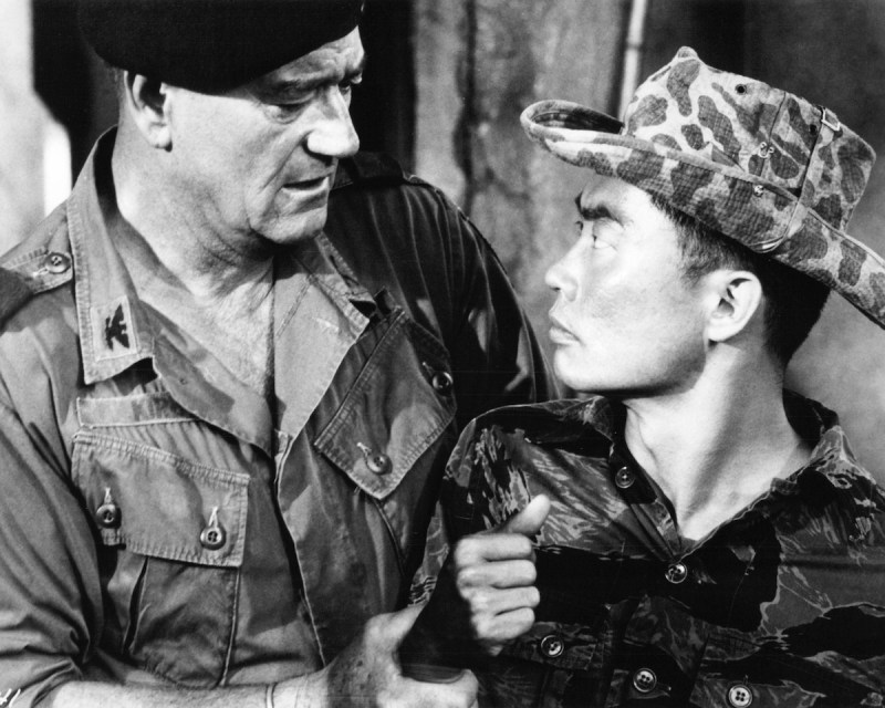 American actors John Wayne (1907 - 1979, left) as Colonel Mike Kirby, and George Takei as Captain Nim, in 'The Green Berets', directed by John Wayne, Ray Kellogg and Mervyn LeRoy, 1968. (Photo by Silver Screen Collection/Getty Images)