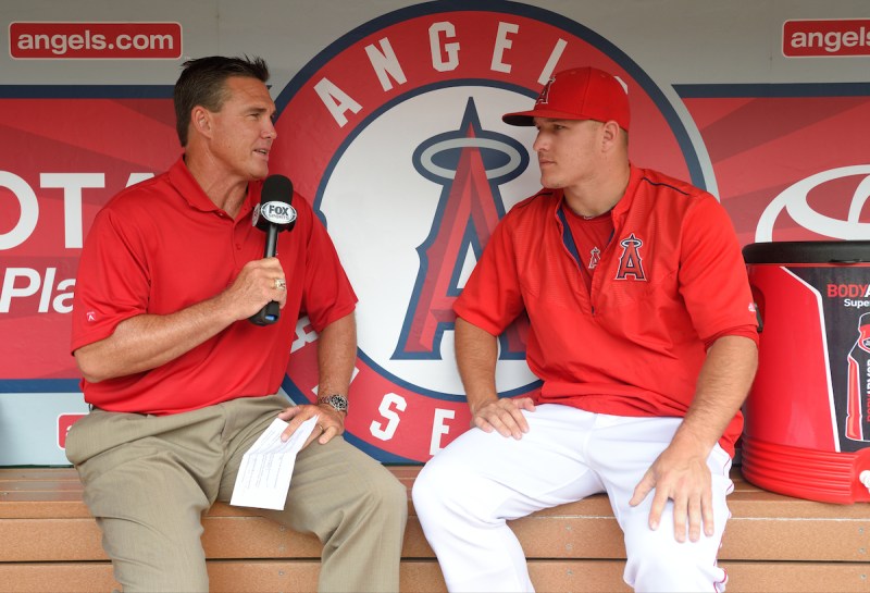 ANAHEIM, CA - JUNE 28: Former Los Angeles Angels of Anaheim player Tim Salmon interviews Mike Trout #27 of the Los Angeles Angels of Anaheim in the dugout before the game against the Seattle Mariners at Angel Stadium of Anaheim on June 28, 2015 in Anaheim, California. (Photo by Matt Brown/Angels Baseball LP/Getty Images)