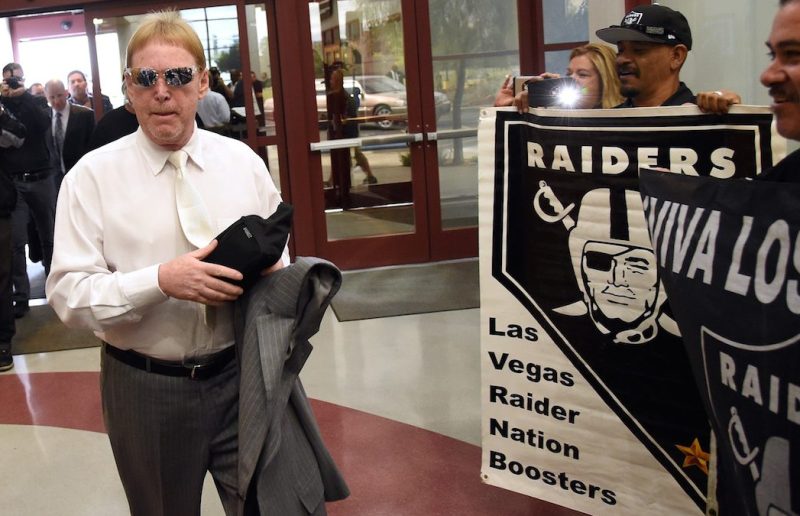 LAS VEGAS, NV - APRIL 28: Oakland Raiders owner Mark Davis walks past fans holding Raiders signs as he arrives at a Southern Nevada Tourism Infrastructure Committee meeting at UNLV on April 28, 2016 in Las Vegas, Nevada. Davis told the committee he is willing to spend USD 500 million as part of a deal to move the team to Las Vegas if a proposed USD 1.3 billion, 65,000-seat domed stadium is built by casino magnate Sheldon Adelson's Las Vegas Sands Corp. and real estate agency Majestic Realty, possibly on a vacant 42-acre lot a few blocks east of the Las Vegas Strip recently purchased by UNLV. (Photo by Ethan Miller/Getty Images)