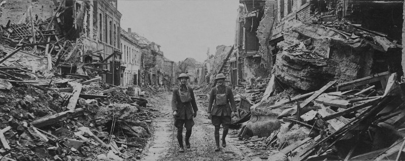 soldiers walking through damaged streets, France. (Photo by Pen & Sword/SSPL/Getty Images)