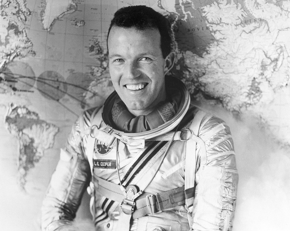Major L. Gordon Cooper poses in front of a map while wearing a space suit. Cooper, a 35 year old from Shawnee, Oklahoma is slated to pilot the next Mercury space flight in which he is expected to circle the earth 18 times in a flight lasting 24 hours. The flight is scheduled for April, 1963. Washington, D.C.