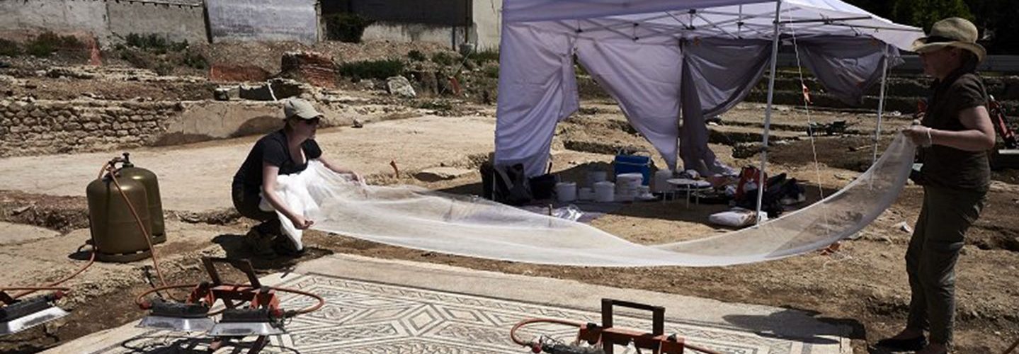 Archaeologists work on a mosaic on July 31, 2017, on the archaeological antiquity site of Sainte-Colombe, near Vienne, eastern France. (Jean-Philippe Ksiazek/AFP/Getty Images)
