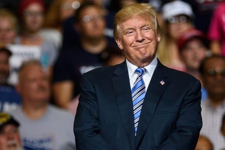 President Donald J. Trump listens as West Virginia Governor Jim Justice announces that he is switching parties to become a republican during the president's campaign rally at the Big Sandy Superstore Arena on August 3, 2017 in Huntington, West Virginia.