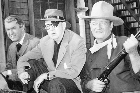 American actors James Stewart (1908 - 1997, left ) and John Wayne (1907 - 1979, right) with director John Ford (1894 - 1973) on the set of? 'The Man Who Shot Liberty Valance', 1962. (Photo by Silver Screen Collection/Getty Images)