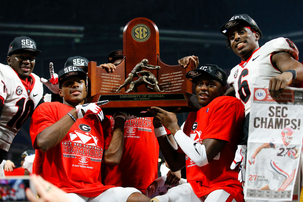 The Georgia Bulldogs hold up the SEC Championship trophy after the SEC Championship game of the Georgia Bulldogs v Auburn Tigers at Mercedes-Benz Stadium in Atlanta, GA. (Todd Kirkland/Icon Sportswire via Getty Images)