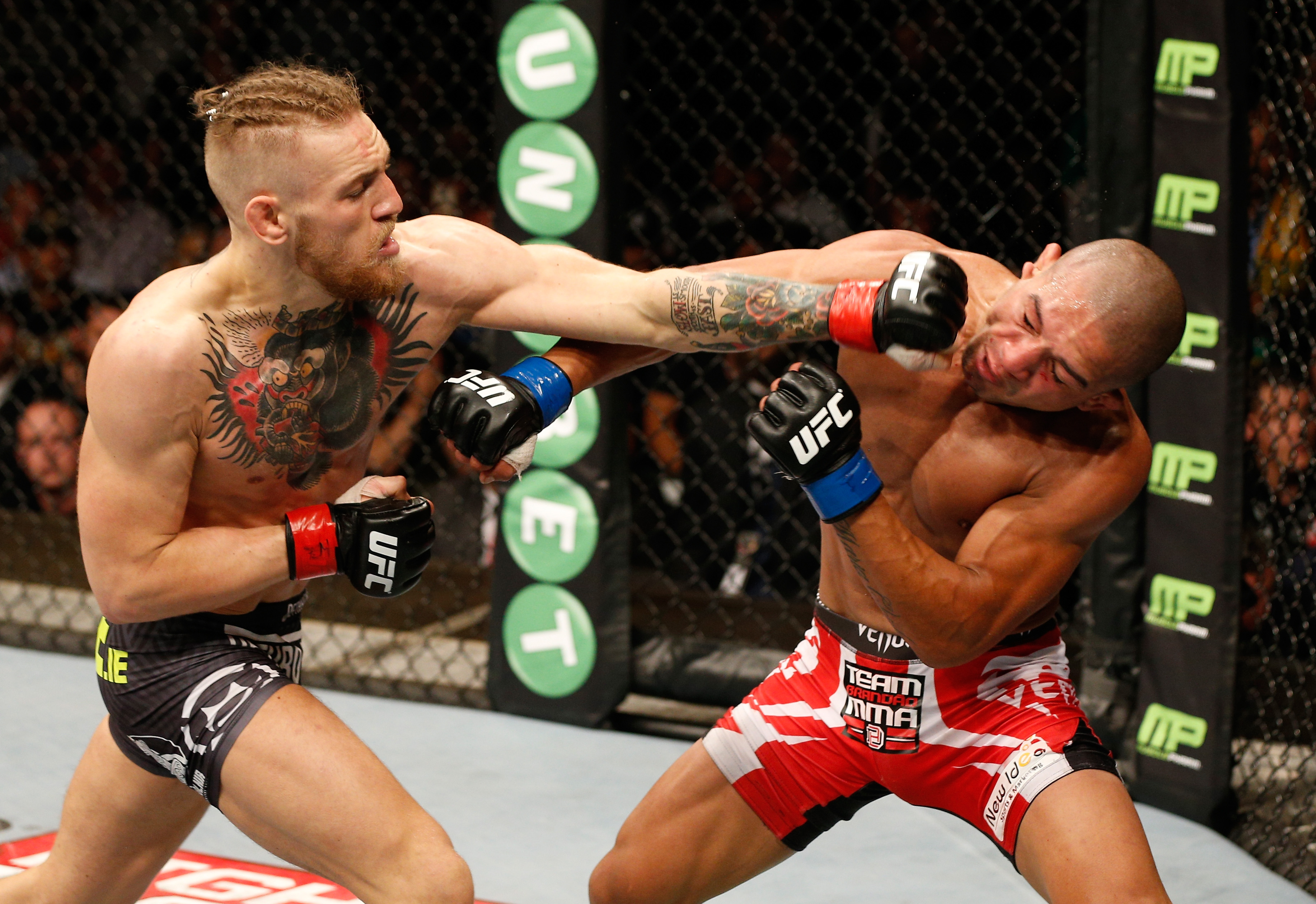 Conor McGregor lands a left to the head of Diego Brandao in their featherweight bout during the UFC Fight Night event at The O2 Dublin on July 19, 2014 in Dublin, Ireland.  (Josh Hedges/Zuffa LLC/Zuffa LLC via Getty Images)