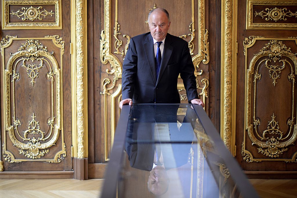 French Gerard Lheritier, president and founder of the Institut des Lettres et des Manuscrits in Paris and founder in 2003 of the Aristophil society poses on April 2, 2014 by the manuscript of "The 120 Days of Sodom" (Martin Bureau/AFP/Getty Images)
