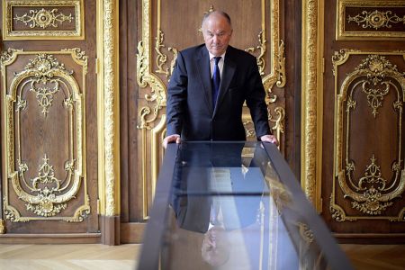 French Gerard Lheritier, president and founder of the Institut des Lettres et des Manuscrits in Paris and founder in 2003 of the Aristophil society poses on April 2, 2014 by the manuscript of "The 120 Days of Sodom" (Martin Bureau/AFP/Getty Images)