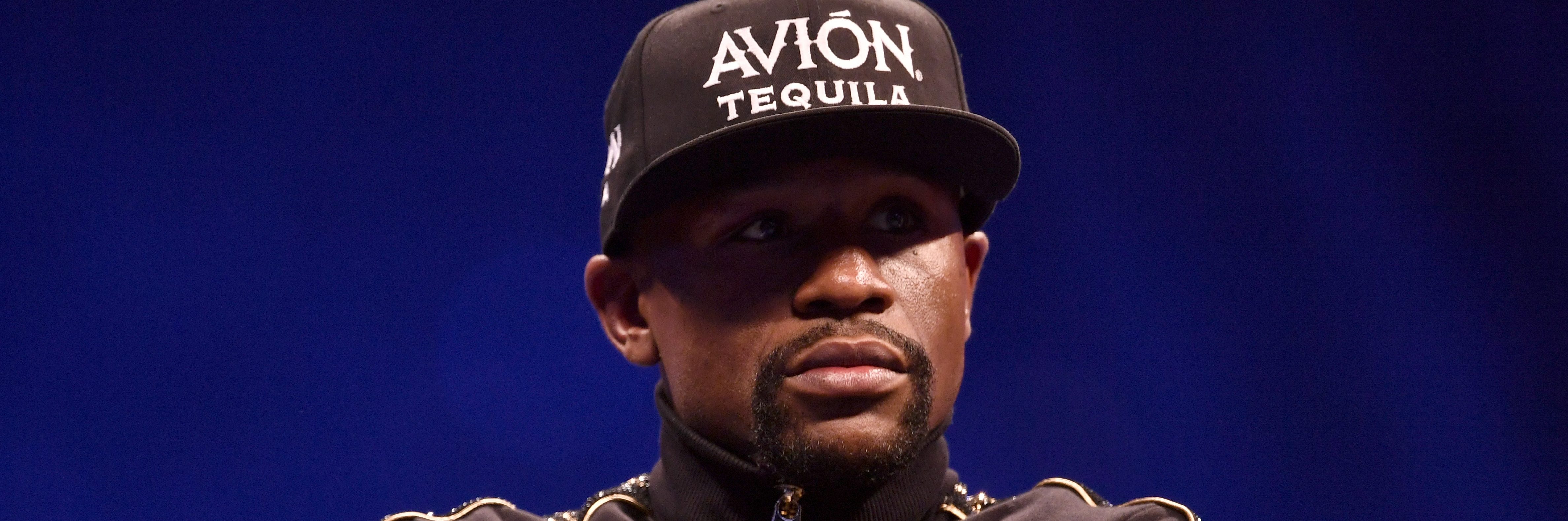 Floyd Mayweather Jr. sits onstage during a news conference.  (Photo by Jeff Bottari/Zuffa LLC/Zuffa LLC via Getty Images)