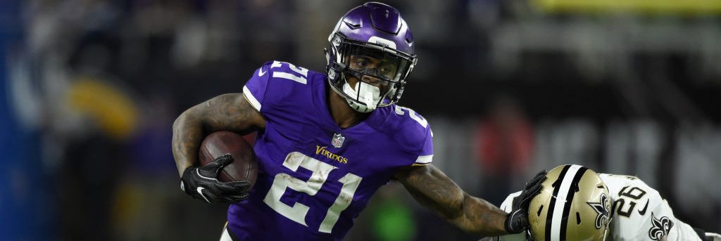 Jerick McKinnon #21 of the Minnesota Vikings carries the ball and stiff arms defender P.J. Williams #26 of the New Orleans Saints. (Photo by Hannah Foslien/Getty Images)
