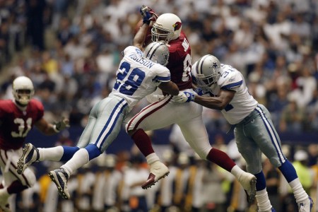 Darren Woodson #28 and Roy Williams #31 of the Dallas Cowboys tackle tight end Freddie Jones #85 of the Arizona Cardinals on the incomplete pass at Texas Stadium on October 5, 2003 in Irving, Texas. (Photo by Ronald Martinez/Getty Images)
