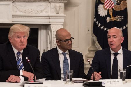 US President Donald Trump (L) and Microsoft CEO Satya Nadella (C) listen to Amazon CEO Jeff Bezos (R) during an American Technology Council roundtable at the White House in Washington, DC, on June 19, 2017. / AFP PHOTO / NICHOLAS KAMM        (Photo credit should read NICHOLAS KAMM/AFP/Getty Images)