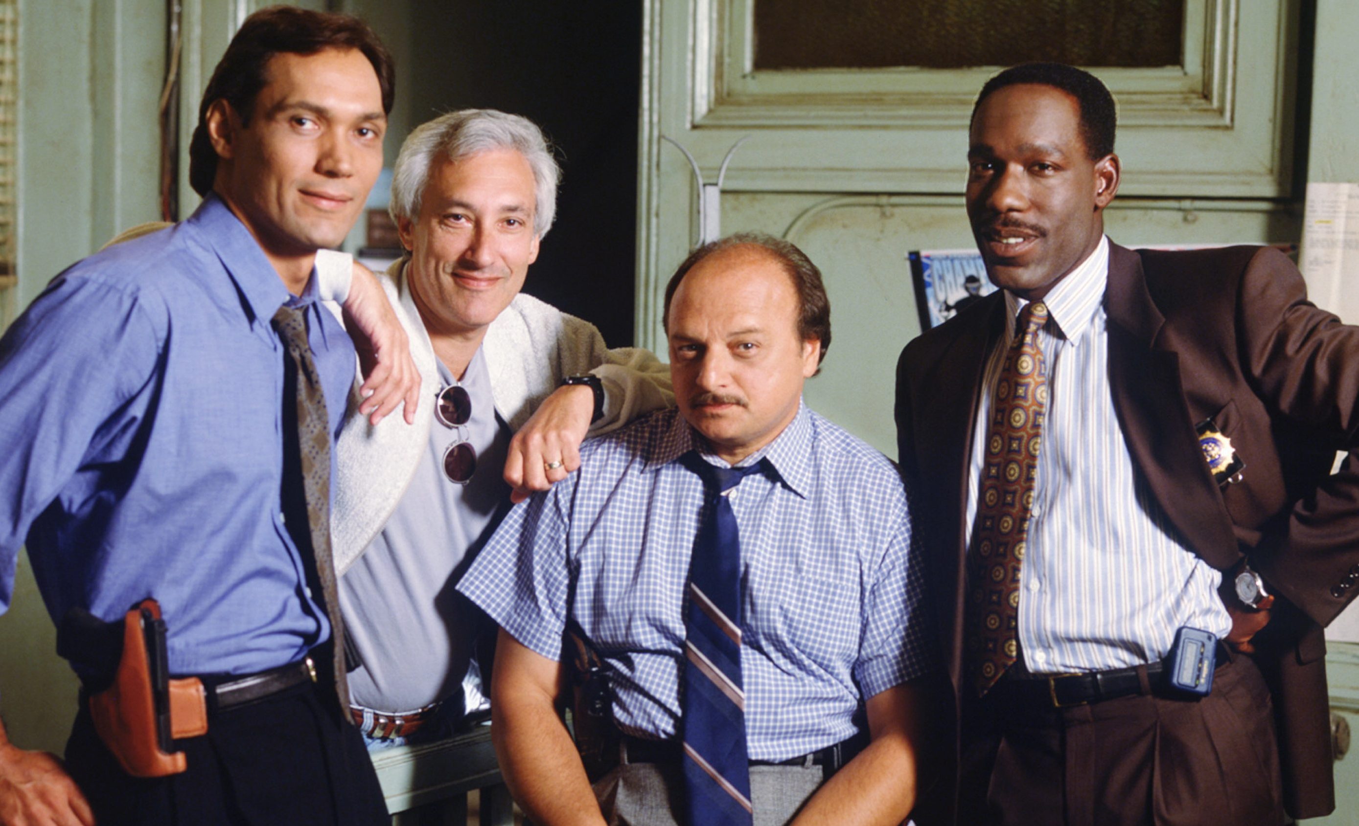 Jimmy Smits (left, as Det. Bobby Simone) joined executive producer Steven Bochco (second from left) and co-stars Dennis Franz (Det. Andy Sipowicz) and James McDaniel (Lt. Arthur Fancy) on the set of the ABC police drama "NYPD Blue." Smits, who replaced David Caruso in the second season, was first seen in the "Simone Says" episode of the series.,  (Photo by Timothy White/ABC via Getty Images)