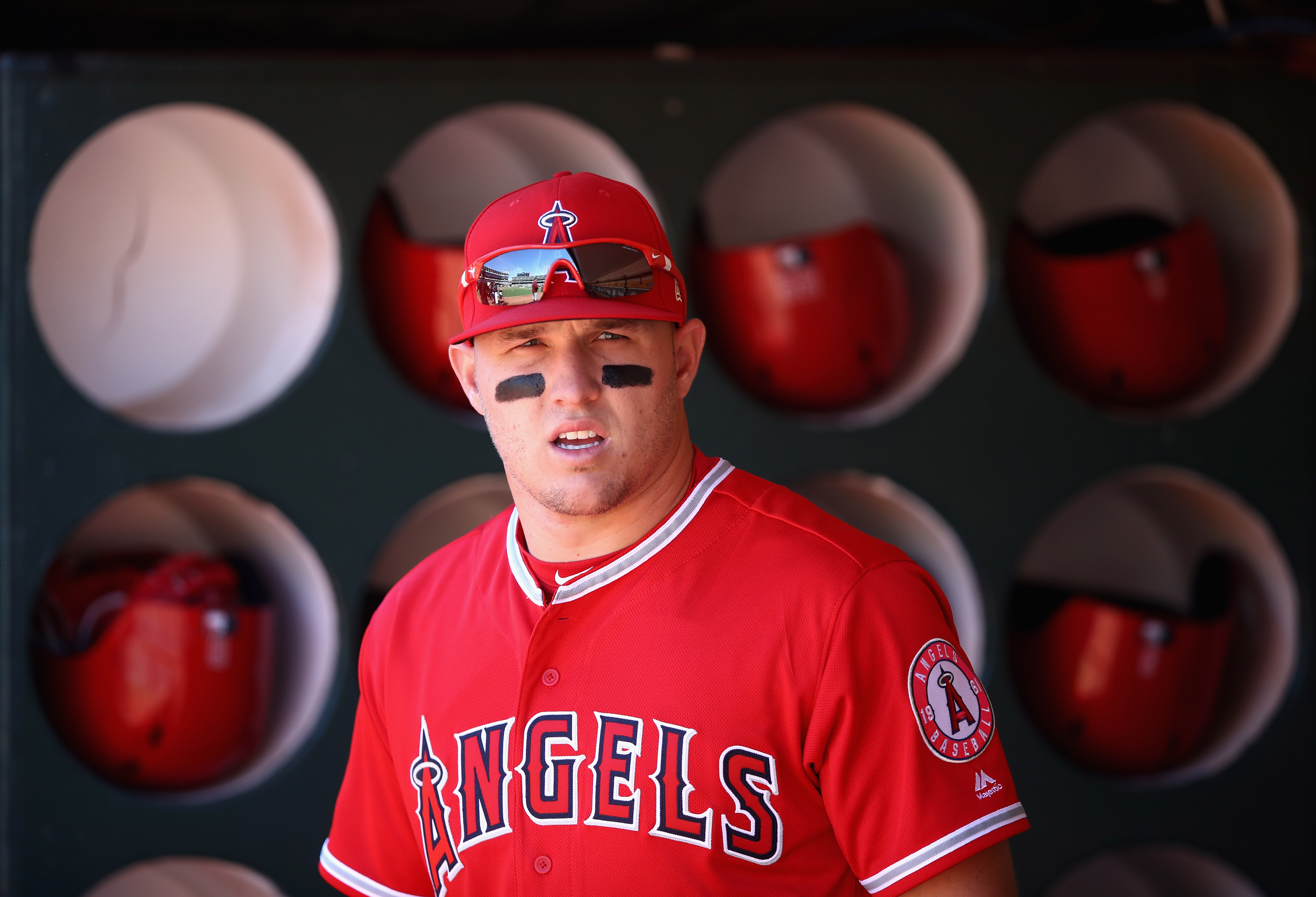 Mike Trout #27 of the Los Angeles Angels stands in the dugout before their game against the Oakland Athletics at Oakland Alameda Coliseum on March 29, 2018 in Oakland, California.  (Photo by Ezra Shaw/Getty Images)