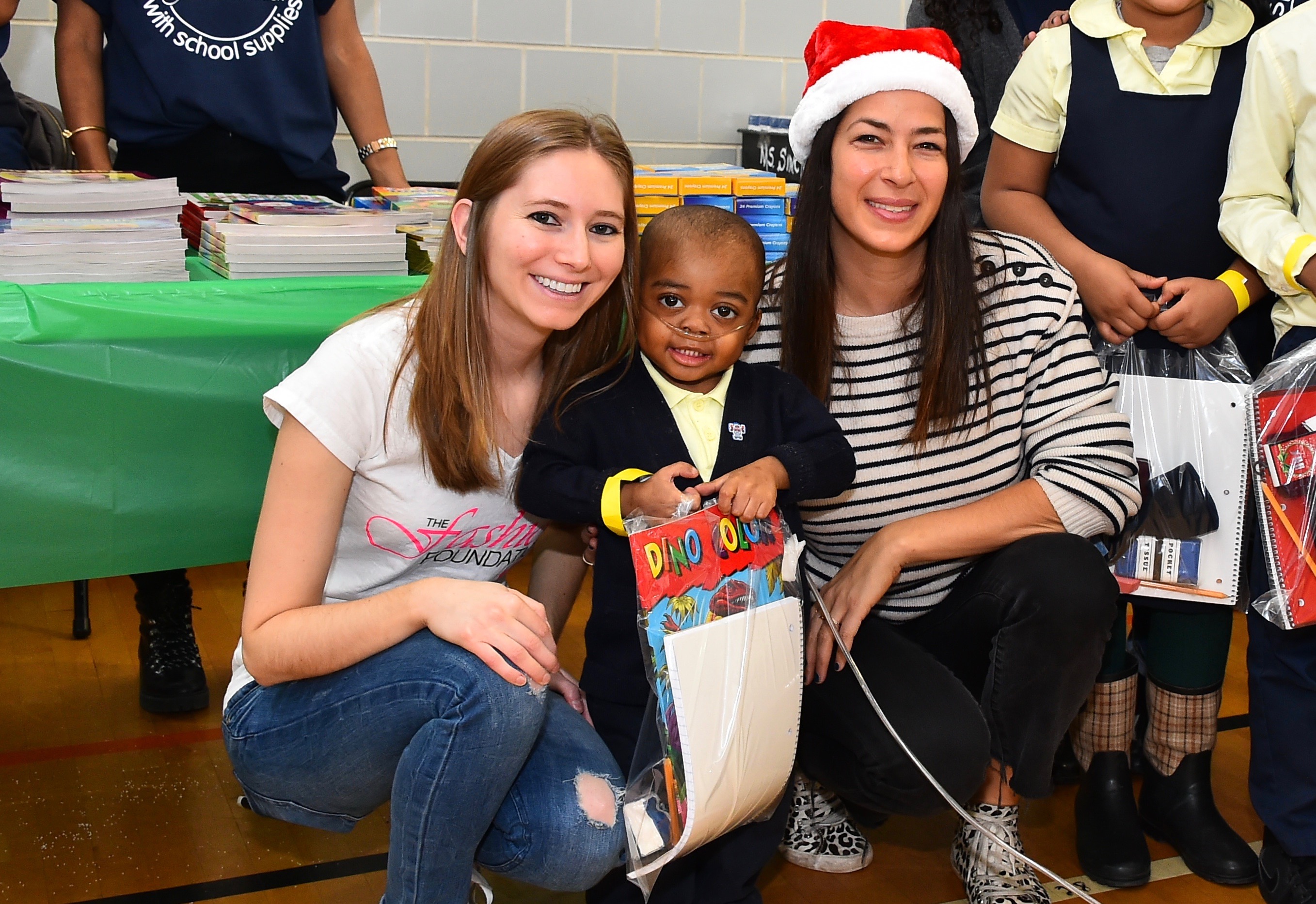 (L to R) The Fashion Foundation founder Amanda Munz, a student  at a Brooklyn elementary school who received donated supplies and designer Rebecca Minkoff on December, 2016. (Courtesy of Amanda Munz)
