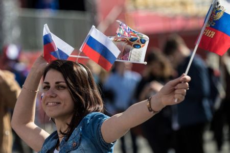 A woman wears Russian flags on her head during the opening ceremony of the FIFA Fan Fest in Nizhny Novgorod on June 14, 2018, ahead of the Russia 2018 World Cup. (Photo by MARTIN BERNETTI/AFP/Getty Images)