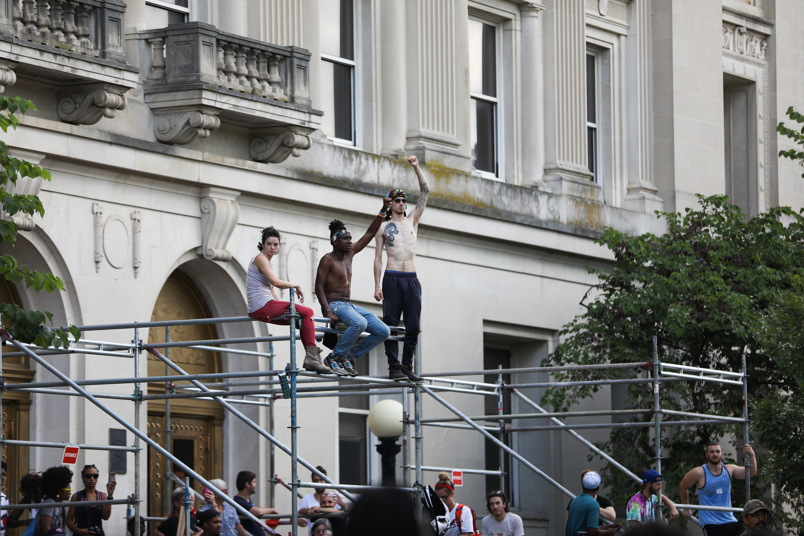 Protesters gather in front of the old Durham County Courthouse where days earlier a confederate statue was toppled by demonstrators, in Durham, North Carolina, on August 18, 2017. / AFP PHOTO / Logan Cyrus        (Photo credit should read LOGAN CYRUS/AFP/Getty Images)
