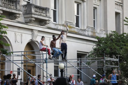 Protesters gather in front of the old Durham County Courthouse where days earlier a confederate statue was toppled by demonstrators, in Durham, North Carolina, on August 18, 2017. / AFP PHOTO / Logan Cyrus        (Photo credit should read LOGAN CYRUS/AFP/Getty Images)