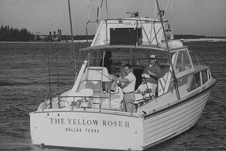 Teamster leader Jimmy Hoffa casting his reel into water off side of boat called The Yellow Rose II during fishing trip, w. his cohorts behind him, off coast of Miami, FL. (Photo by Frank Dandridge/Pix Inc./The LIFE Images Collection/Getty Images)