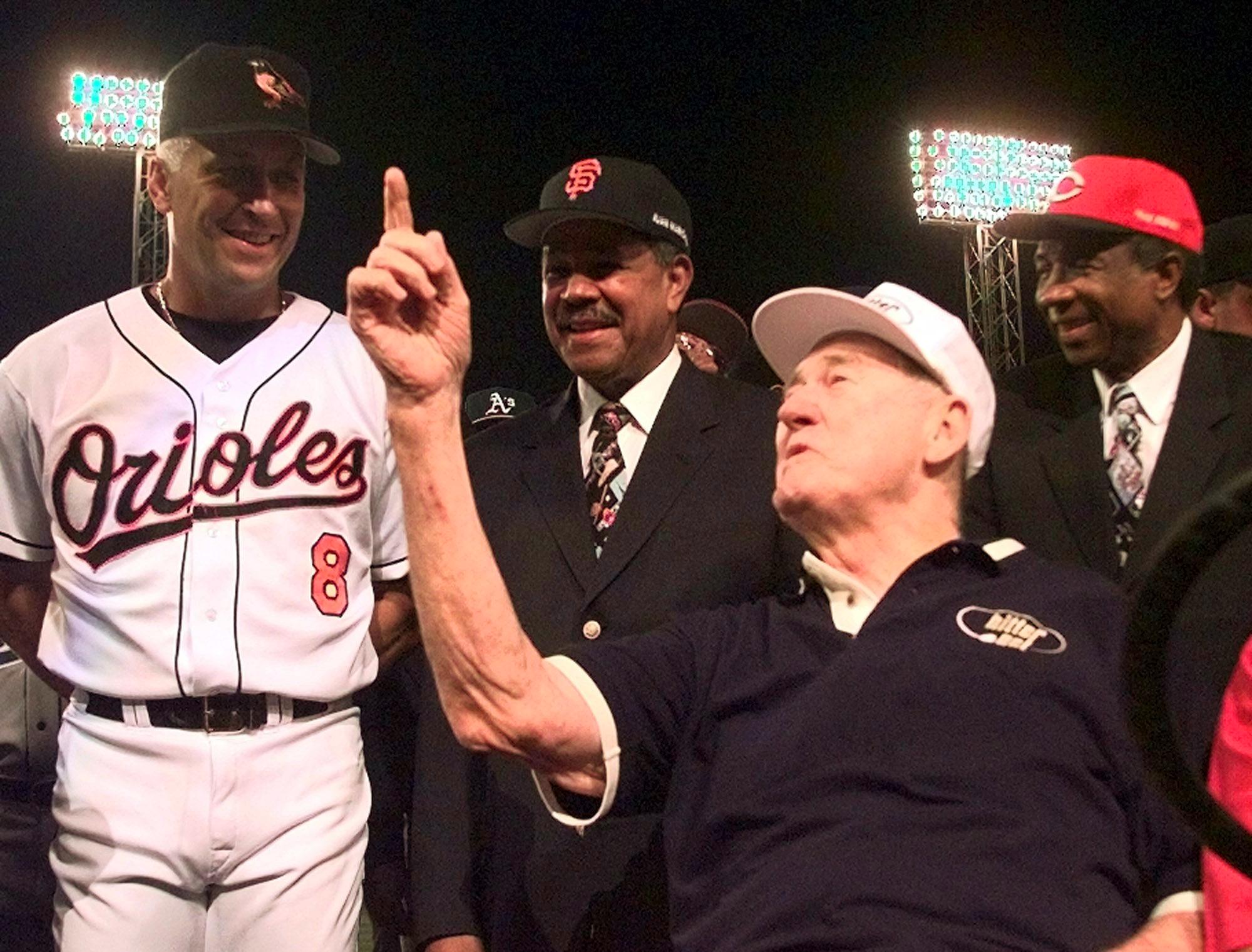 Baseball legend and former Boston Red Sox star Ted Williams (2ndR) talks with All-Star Cal Ripken, Jr. of the Baltimore Orioles (L), as All-Century players Juan Marichal (2ndL) and Frank Robinson (R) listen July 13, 1999 at Boston's Fenway Park prior to the start of the All-Star Game at Fenway Park. Williams threw out the honorary first pitch. (ELECTRONIC IMAGE)  (Photo credit should read MATT YORK/AFP/Getty Images)