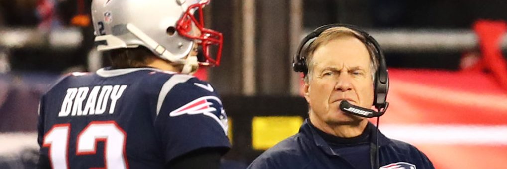 Head Coach Bill Belichick looks on as Tom Brady #12 of the New England Patriots walks by during the AFC Championship Game against the Jacksonville Jaguars at Gillette Stadium on January 21, 2018 in Foxborough, Massachusetts.  (Photo by Adam Glanzman/Getty Images)