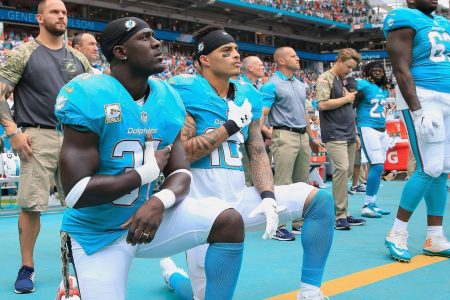 Michael Thomas #31 of the Miami Dolphins and  Kenny Stills #10 of the Miami Dolphins take a knee during the national anthem prior to the game against the New York Jets at the Hard Rock Stadium on November 6, 2016 in Miami Gardens, Florida.  (Photo by Chris Trotman/Getty Images)