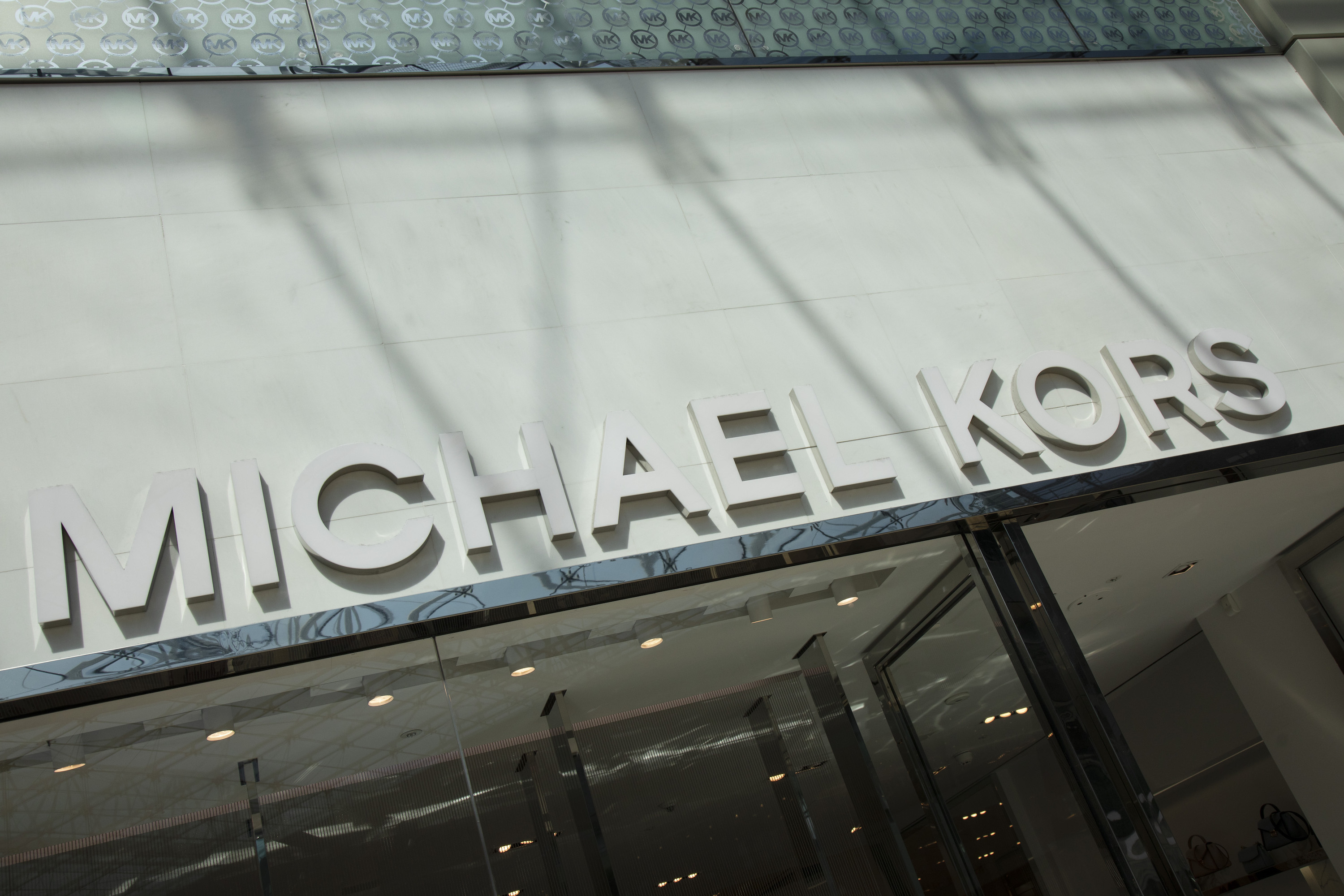Sign for the luxury clothing brand Michael Kors in Birmingham, United Kingdom. Michael Kors is reportedly close to acquiring Versace. (photo by Mike Kemp/In PIctures via Getty Images)
