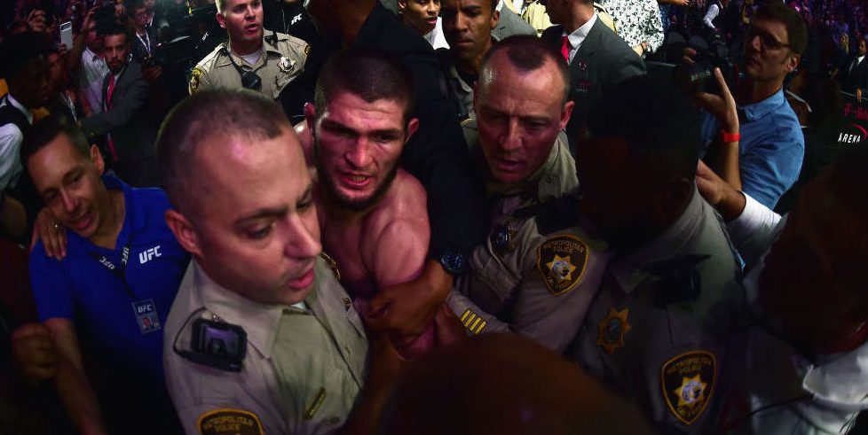 After defeating Conor McGregor at UFC 229, Khabib Nurmagomedov is escorted by Las Vegas police from the T-Mobile Arena after a post-fight melee that involved numerous scuffles inside and outside the octagon. (Photo credit: Harry How/Getty Images)