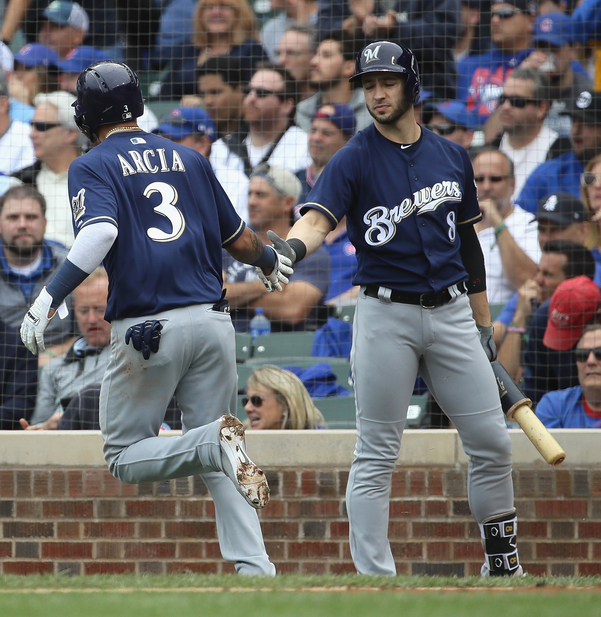 Orlando Arcia #3 of the Milwaukee Brewers is congratulated by Ryan Braun #8 after scoring a run in the 3rd inning against the Chicago Cubs during the National League Tiebreaker Game at Wrigley Field on October 1, 2018 in Chicago, Illinois. (Photo by Jonathan Daniel/Getty Images)