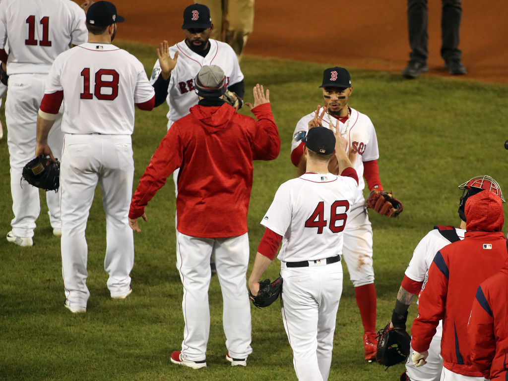 BOSTON - OCTOBER 24: Boston Red Sox player Mookie Betts holds up two fingers with teammates as the Red Sox celebrate the 4-2 win over the Dodgers. (Photo by Stan Grossfeld/The Boston Globe via Getty Images)